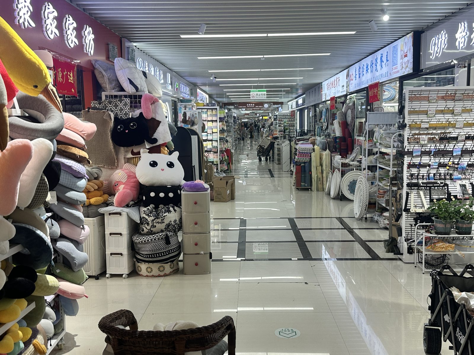 Home goods booth displays in pink and pastel ranges inside the market